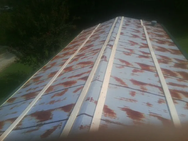 Rusted metal roof panels with new wood purlins before replacement — Storm Damage Roof Repair in Mantachie by Roofing Brothers
